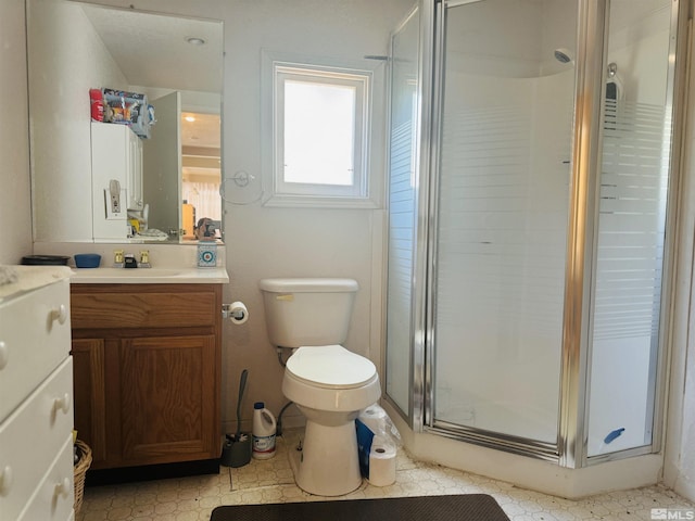 bathroom featuring vanity, an enclosed shower, and toilet