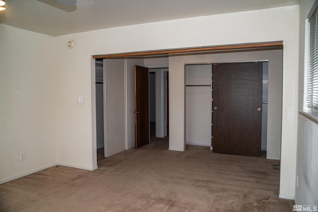 unfurnished bedroom featuring carpet and ceiling fan