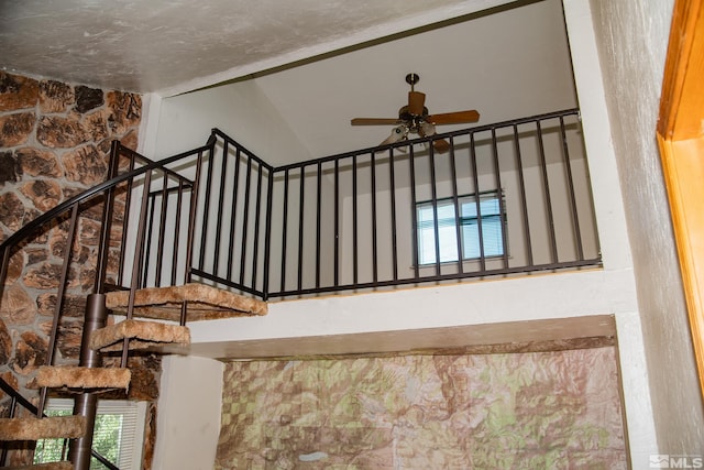 staircase featuring ceiling fan