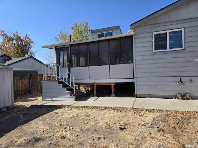 rear view of house featuring a sunroom