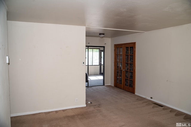 empty room featuring light colored carpet