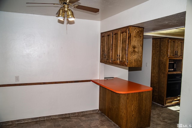 kitchen featuring black oven, ceiling fan, and kitchen peninsula