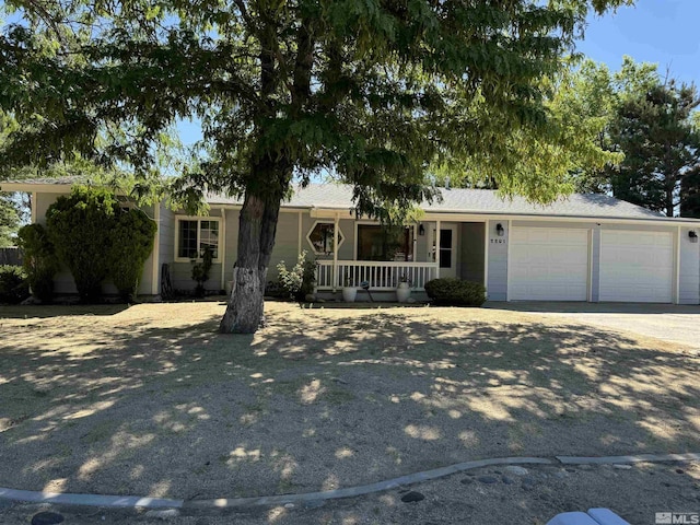 single story home featuring covered porch and a garage