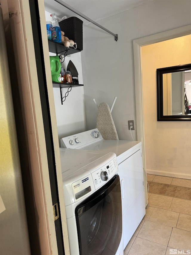 washroom featuring washer and dryer and light tile patterned floors