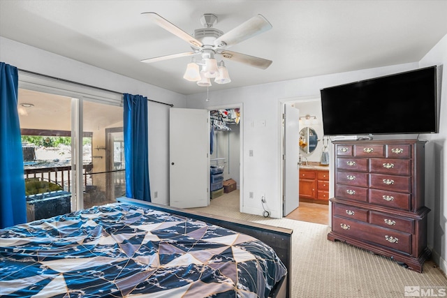 bedroom featuring a closet, connected bathroom, ceiling fan, access to outside, and light colored carpet