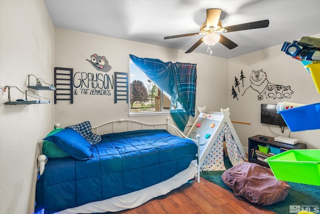 bedroom with hardwood / wood-style flooring and ceiling fan