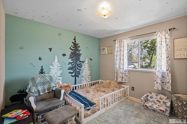 bedroom with carpet flooring and a nursery area