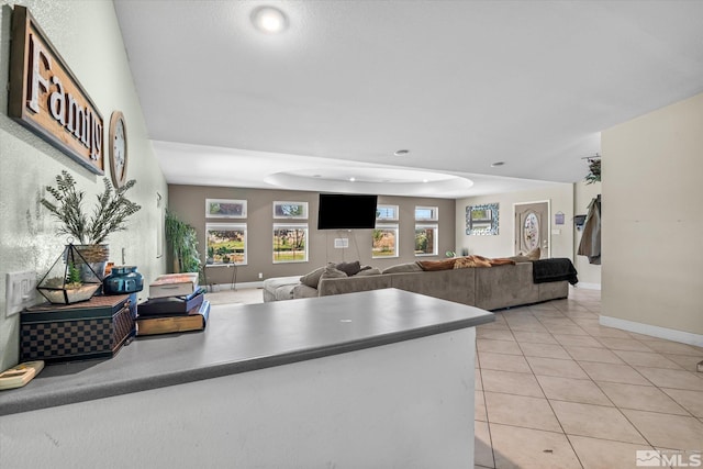 kitchen with light tile patterned floors and a raised ceiling