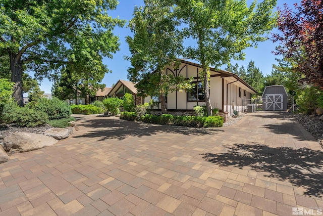 view of front of home featuring a shed