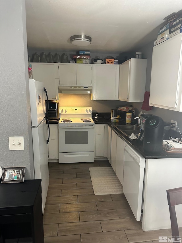 kitchen featuring sink, white cabinets, and white appliances