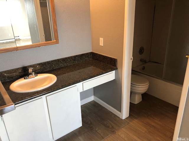 full bathroom with vanity, hardwood / wood-style flooring, toilet, and shower / bath combination