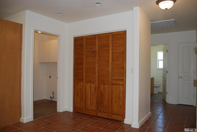 corridor featuring dark tile patterned flooring