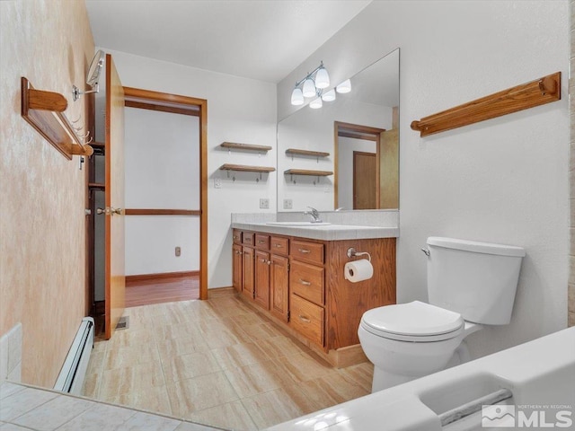 bathroom featuring vanity, a baseboard radiator, and toilet