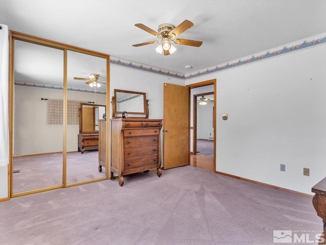 carpeted bedroom with ceiling fan and a closet