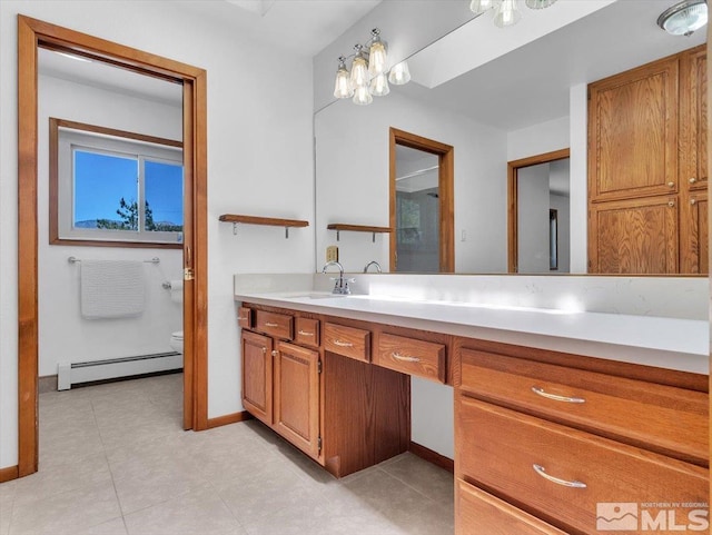 bathroom with vanity, toilet, and a baseboard radiator