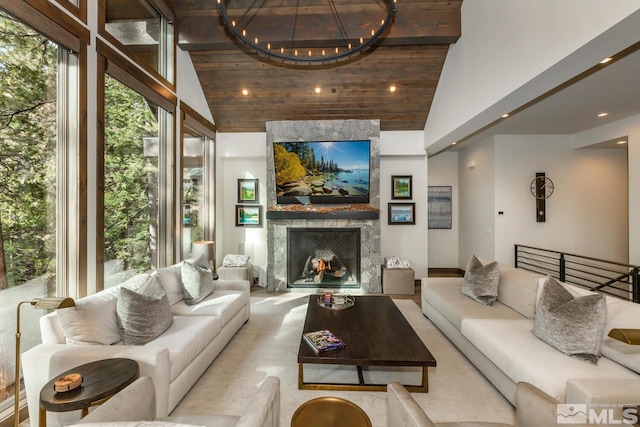 living room with a notable chandelier, high vaulted ceiling, wood ceiling, and a fireplace