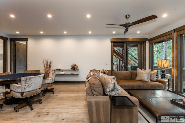 living room with ceiling fan and light wood-type flooring