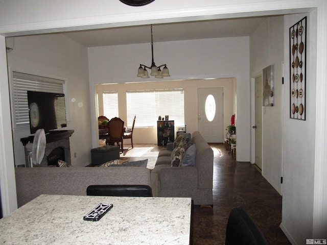 living area featuring a chandelier and a fireplace