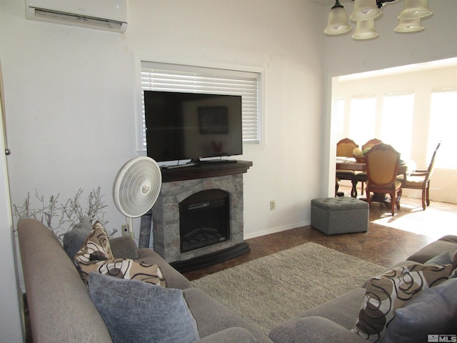 living room featuring baseboards, a fireplace, and a wall mounted AC