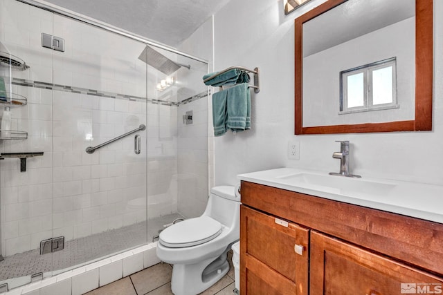 bathroom with walk in shower, tile patterned floors, toilet, and vanity