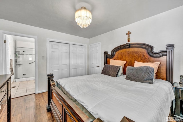 bedroom with a closet, a chandelier, and light wood-type flooring