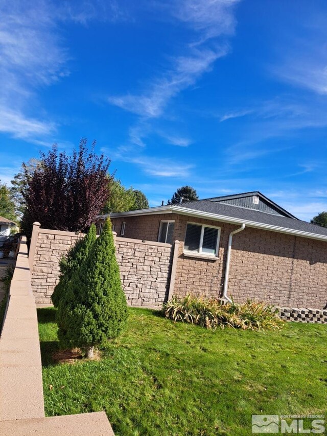 single story home featuring a garage and a front yard