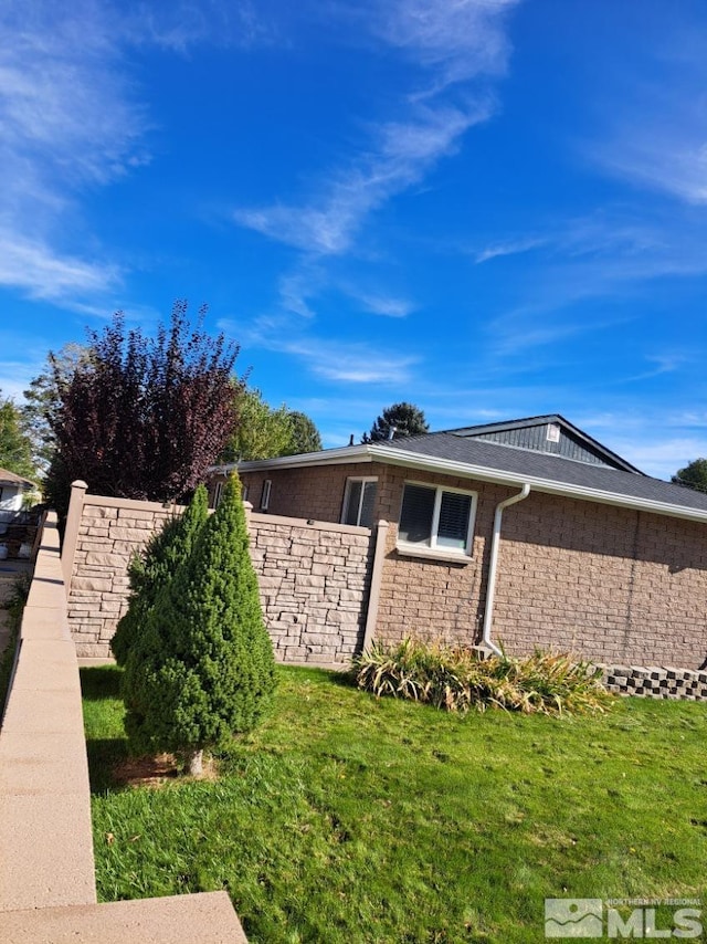 view of side of home featuring a yard