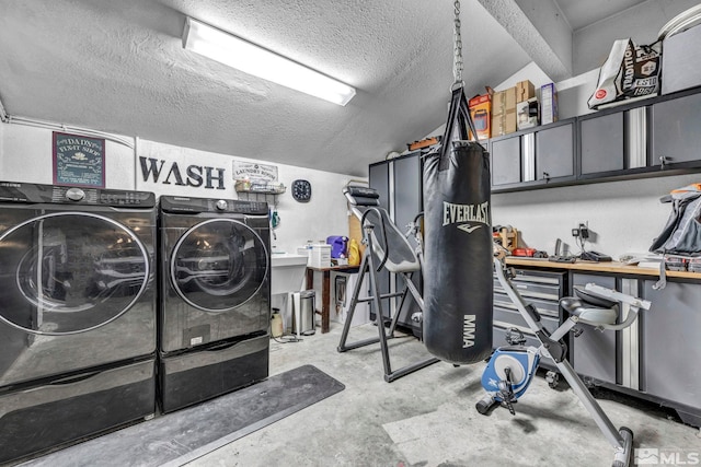 laundry area with a textured ceiling and washer and clothes dryer