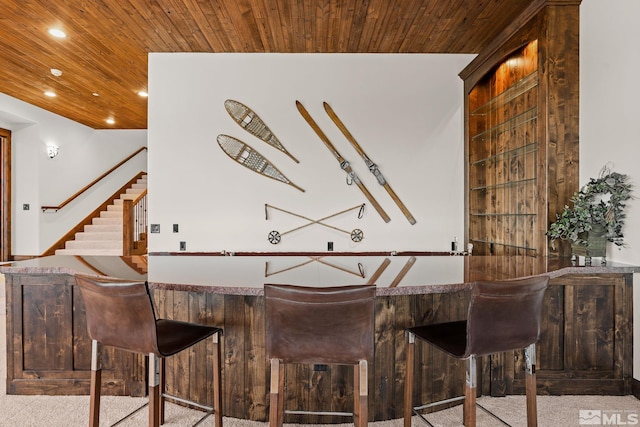 bar with built in shelves, carpet flooring, and wood ceiling