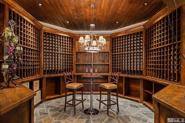 wine room with a notable chandelier and wooden ceiling