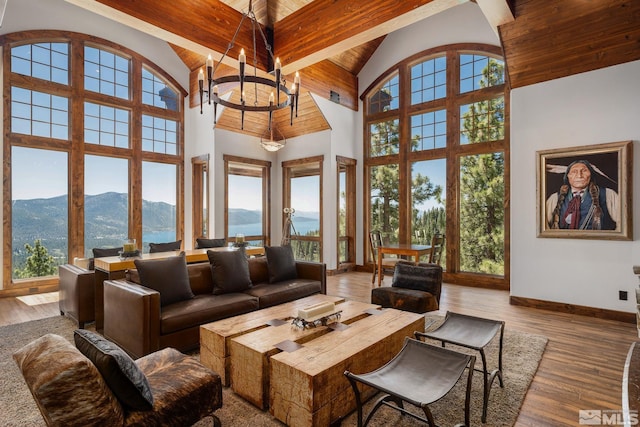 living room with high vaulted ceiling, a mountain view, and a healthy amount of sunlight