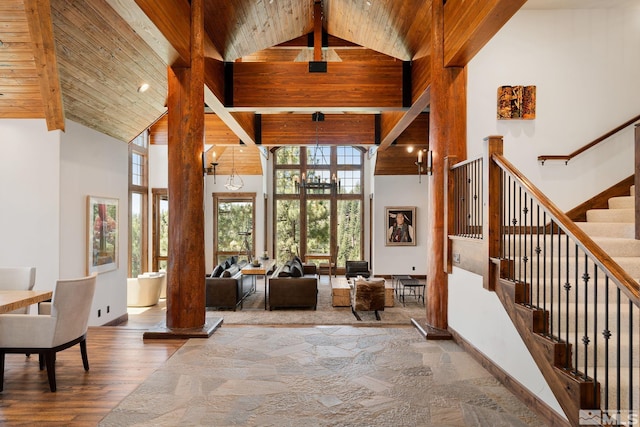 entrance foyer featuring a notable chandelier, high vaulted ceiling, hardwood / wood-style floors, and wood ceiling