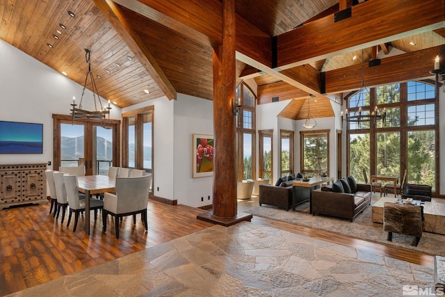 dining area with a wealth of natural light, high vaulted ceiling, and hardwood / wood-style floors