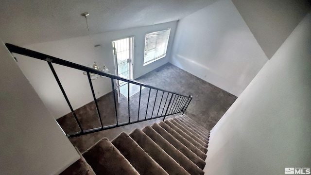 stairway featuring a towering ceiling