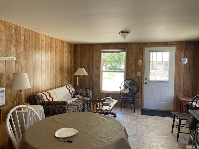 dining room featuring wood walls