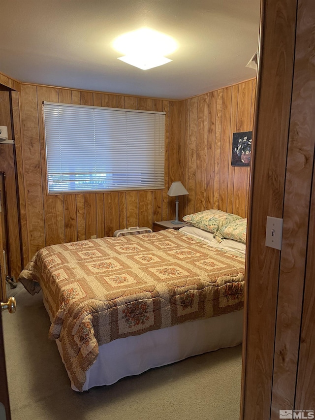 carpeted bedroom with wooden walls