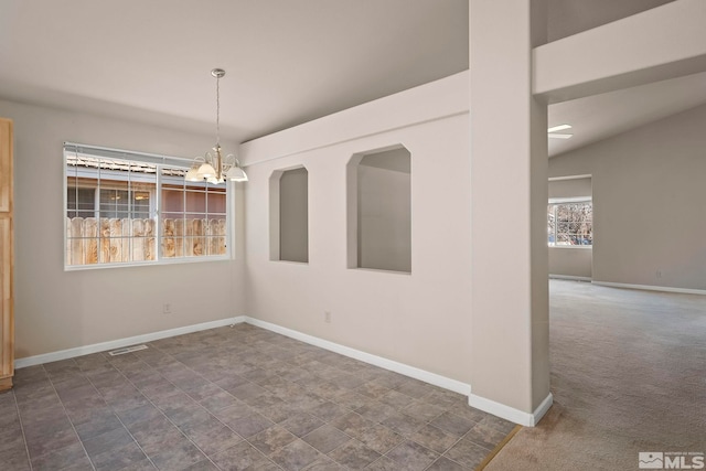 unfurnished dining area featuring dark carpet, an inviting chandelier, and lofted ceiling