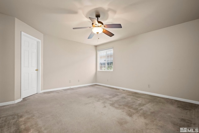 empty room featuring ceiling fan and carpet flooring