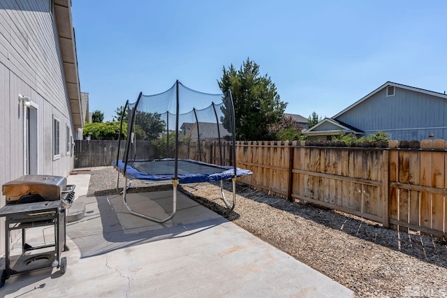 view of patio featuring a trampoline and grilling area