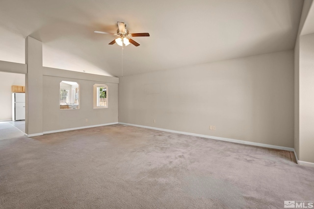 unfurnished living room featuring light carpet, high vaulted ceiling, and ceiling fan