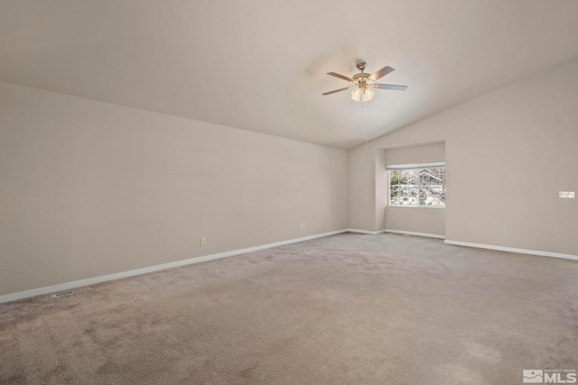 carpeted empty room with ceiling fan and lofted ceiling