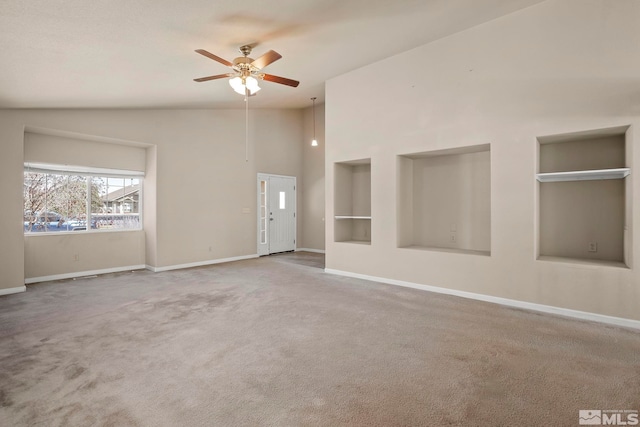 carpeted spare room with ceiling fan and lofted ceiling