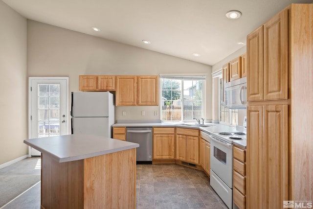 kitchen featuring white appliances, a center island, lofted ceiling, light brown cabinets, and sink