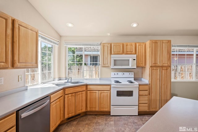 kitchen featuring sink, white appliances, and lofted ceiling