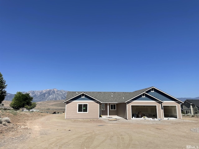 view of front of property with a mountain view and a garage