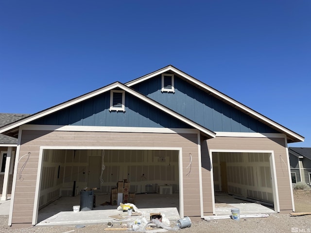 back of property with a garage