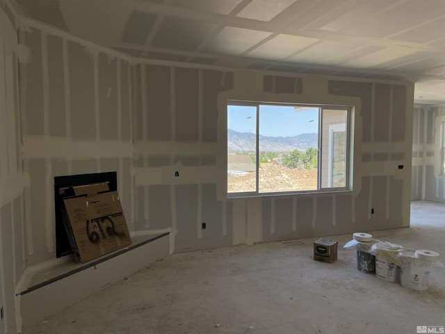 unfurnished living room featuring a mountain view