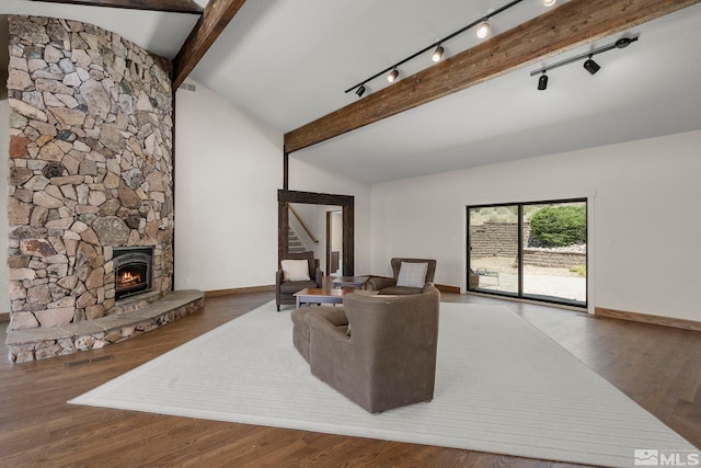 living room with hardwood / wood-style flooring, lofted ceiling with beams, and track lighting