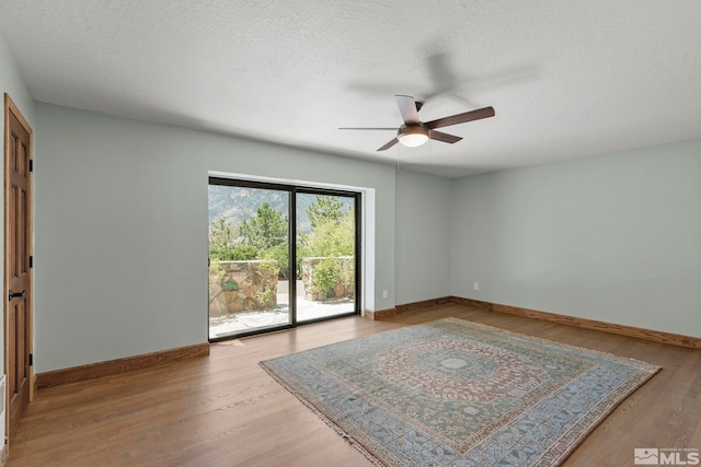 spare room featuring light wood-type flooring and ceiling fan
