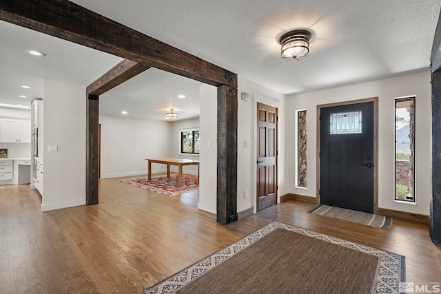 foyer entrance featuring hardwood / wood-style floors